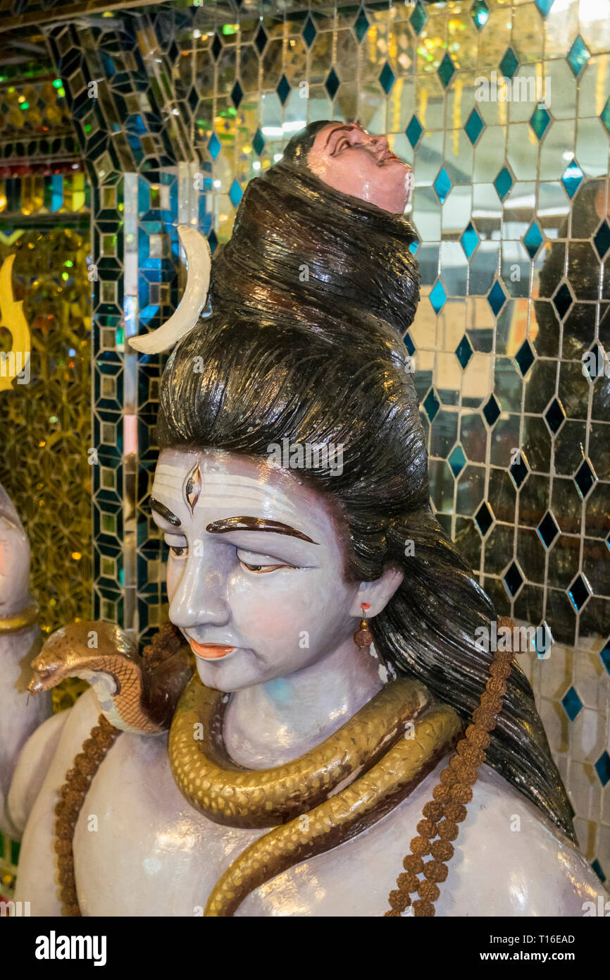 The unique Arulmigu Sri Rajakaliamman Glass Temple in Johor Bahru, Malaysia. The interior is completely covered in glass tiles. Two headed man detail. Stock Photo