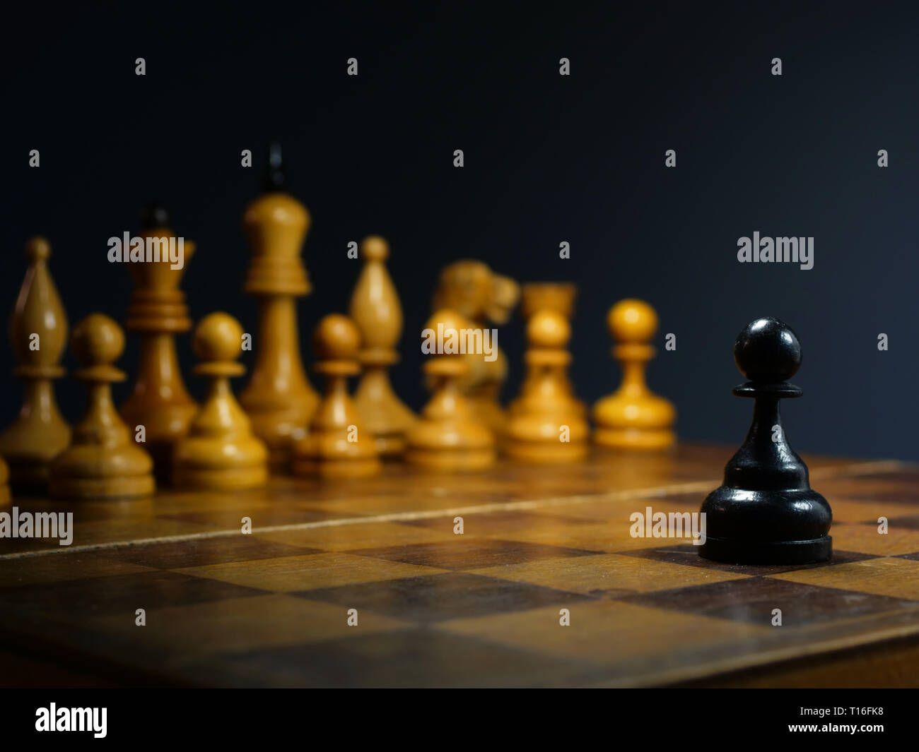 Competition in business and challenge. Black pawn on a desk. Stock Photo