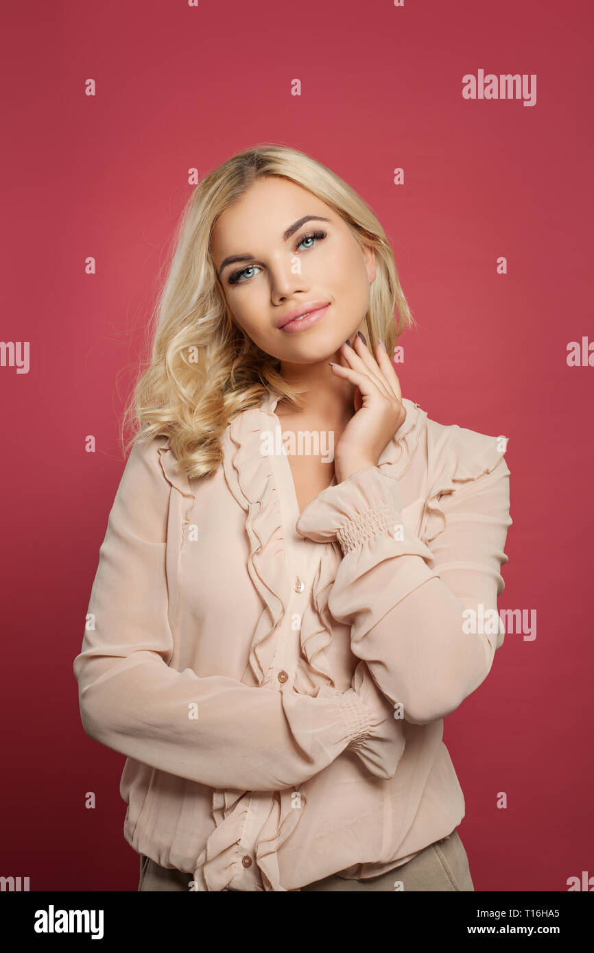 Portrait of a pretty smiling woman posing on pink background Stock ...