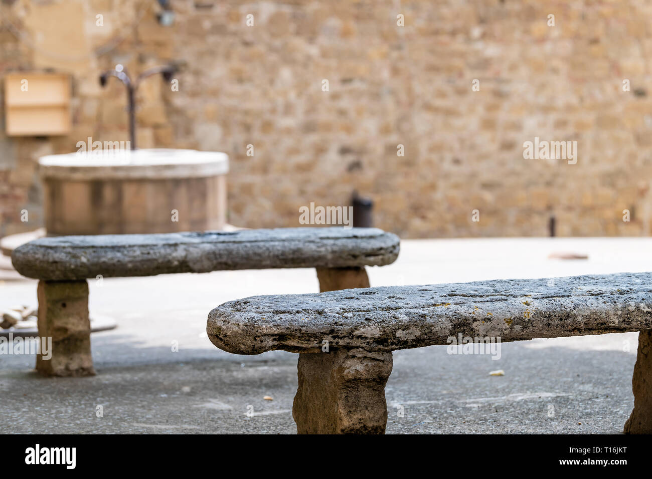Monticchiello, Italy Val D'Orcia countryside in Tuscany with empty square in small town village with nobody and stone benches Stock Photo