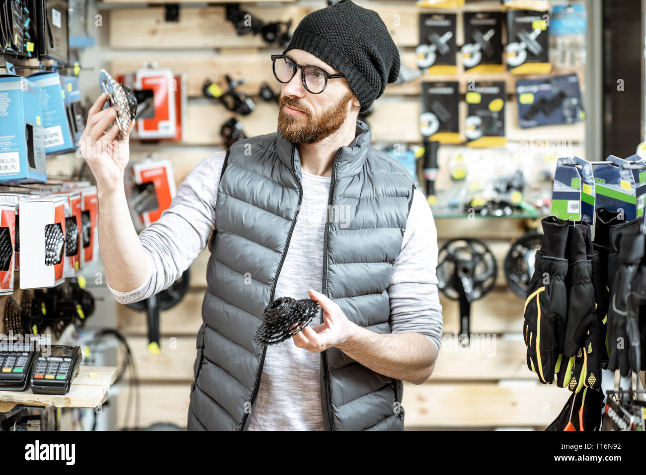 Stylish man choosing gear stars, buying bicycle parts at the small bicycle shop Stock Photo Alamy
