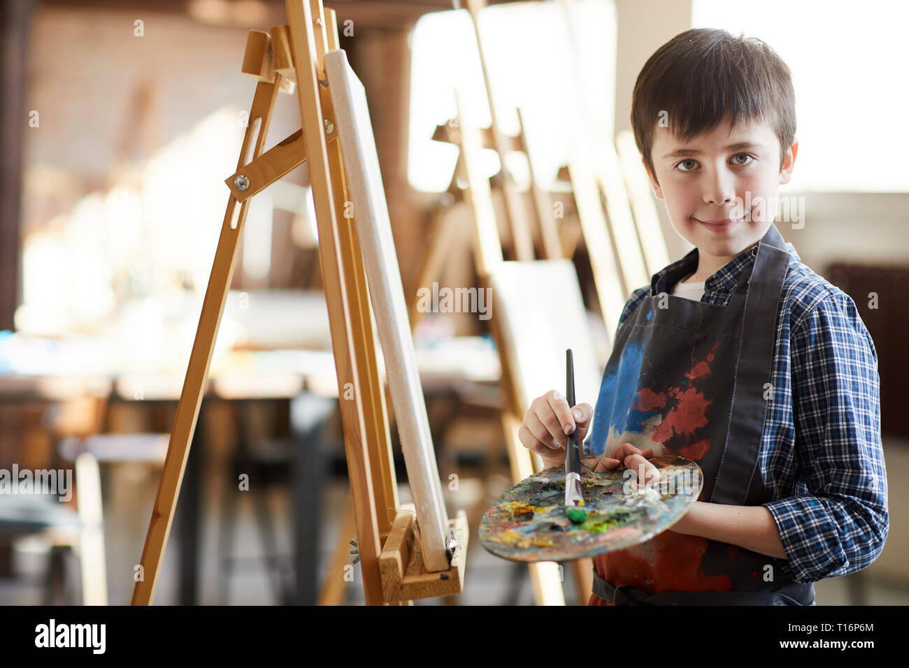 Cute Little Boy Posing by Easel Stock Photo Alamy