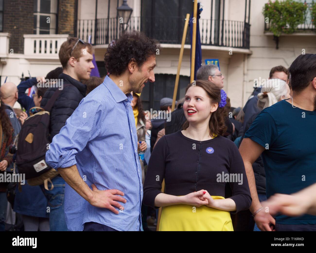Young woman looking up at older man with aqualine nose at Revoke Article 50 Brexit rally Stock Photo
