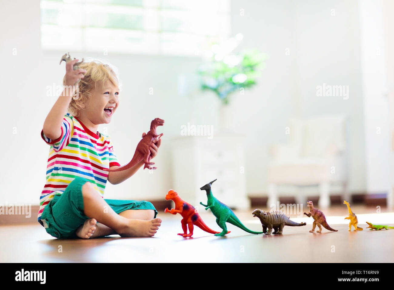 kids playing with dinosaur toys