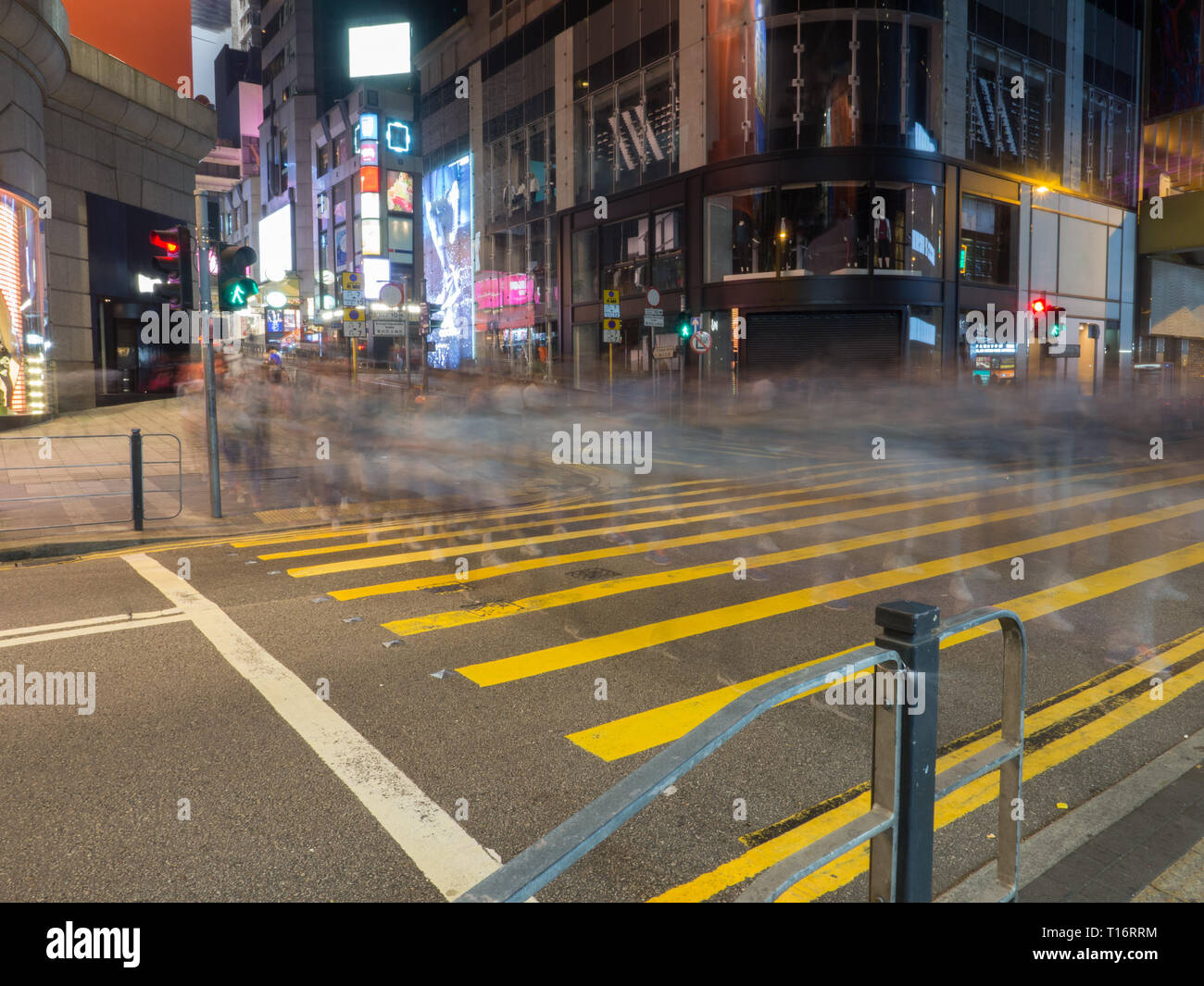 Slow shutter with pedestrians crossing the street in Queen's Road Central Hong Kong. Stock Photo