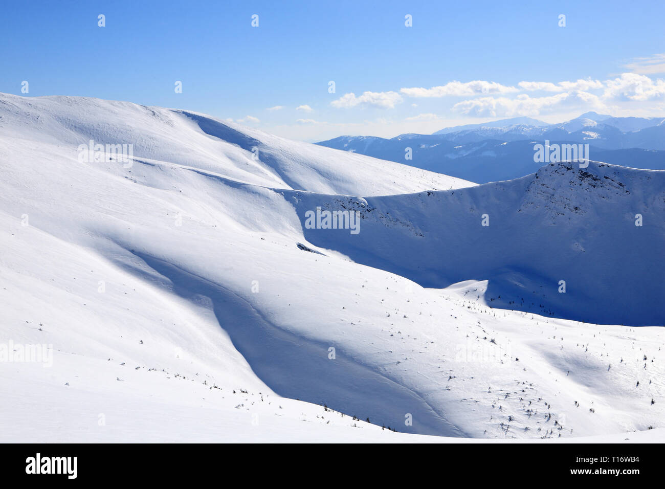 The mountains are covered with snow under a bright blue sky Stock Photo ...