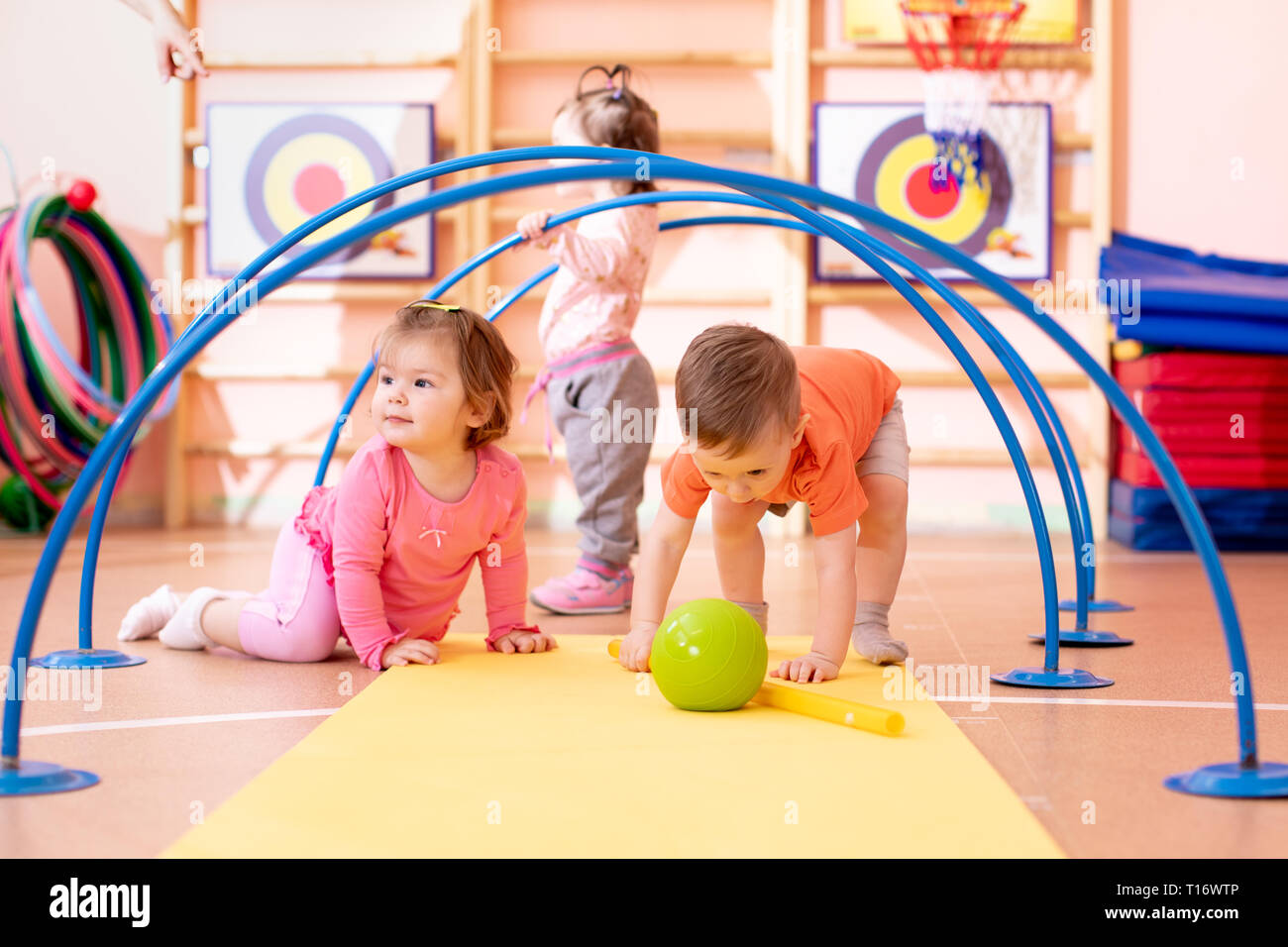 Nursery babies playing together in kindergarten gym Stock Photo - Alamy