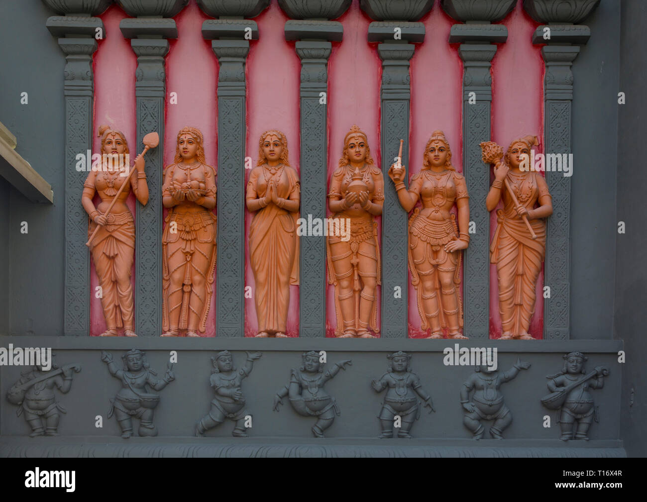Sculptures of six women and seven men on a facade at the exterior of the Hindu temple Sri Senpaga Vinagar, Singapore Stock Photo