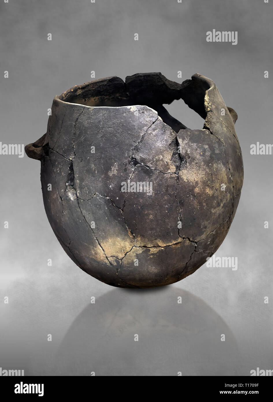 Neolithic terracotta pot . Catalhoyuk collection, Konya Archaeological Museum, Turkey. Against a grey background Stock Photo