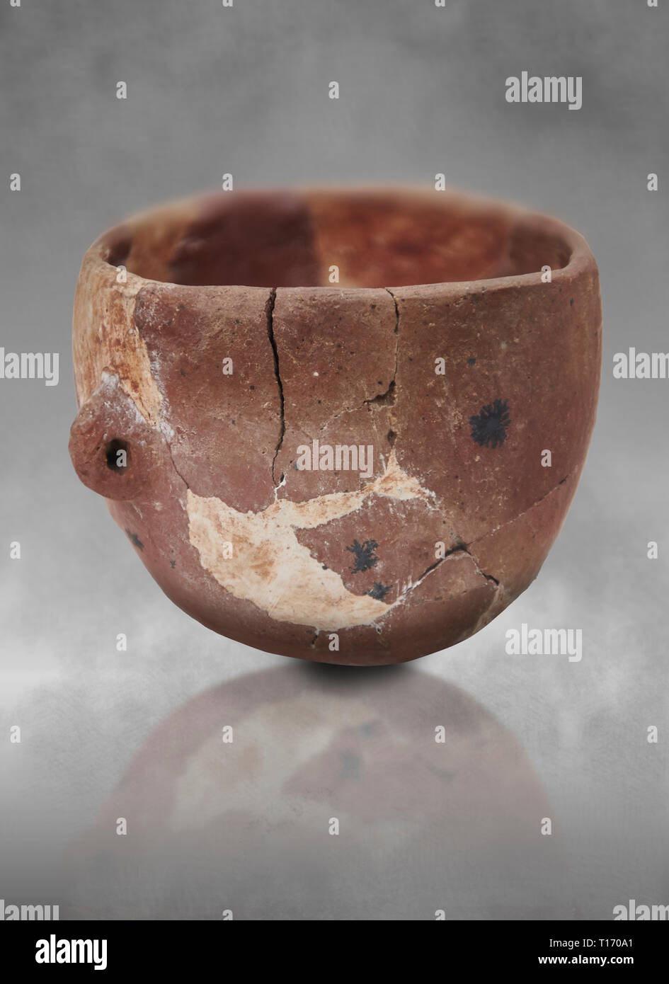 Neolithic terracotta bowl. Catalhoyuk collection, Konya Archaeological Museum, Turkey. Against a grey background Stock Photo