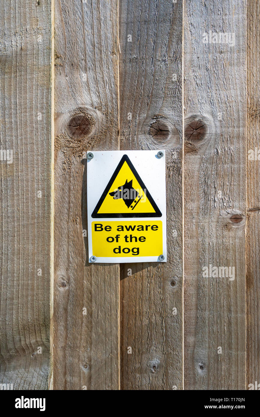 Beware of the dog sign on wooden fence Stock Photo