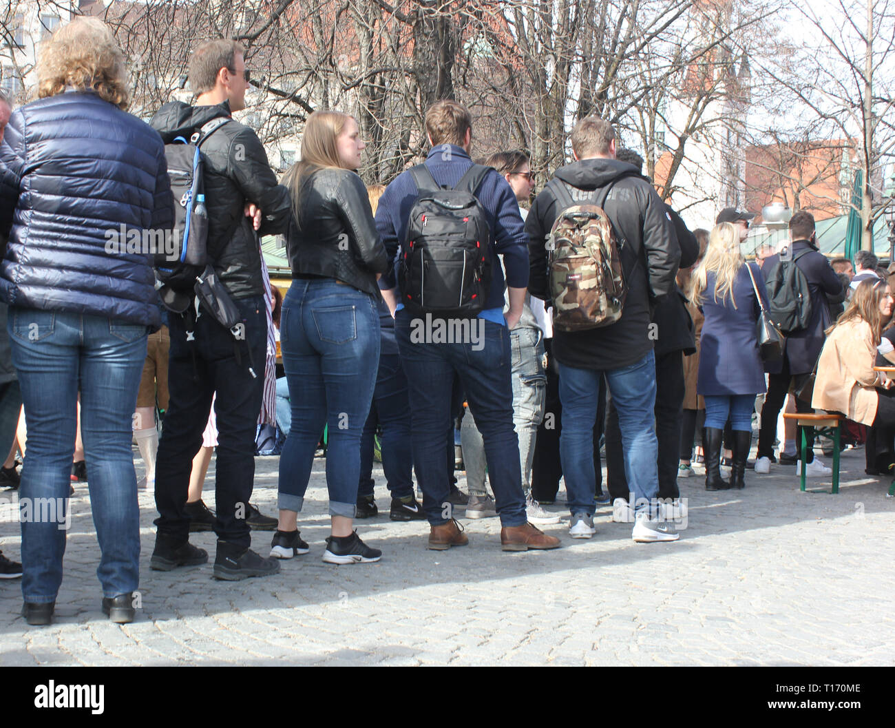 People lining up outside, December, cold season. Stock Photo