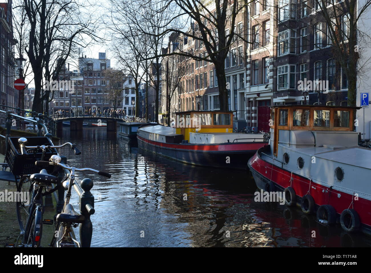 amsterdam - classic canal shot with boats,buildings and bicycles. Stock Photo