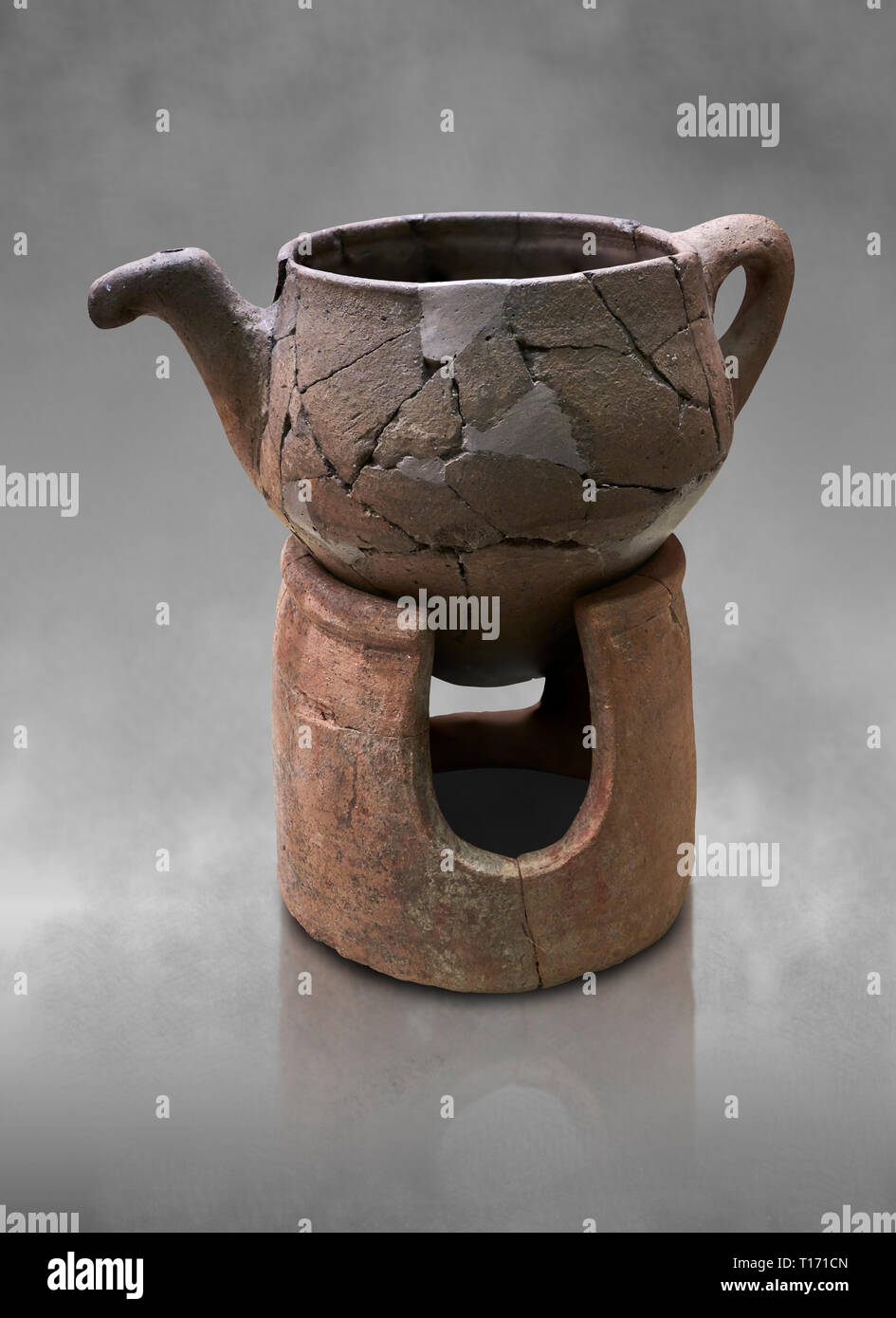 Hittite terra cotta teapot with strainer spout on a charcoa; burner base  . Hittite Period, 1600 - 1200 BC.  Hattusa Boğazkale. Çorum Archaeological M Stock Photo