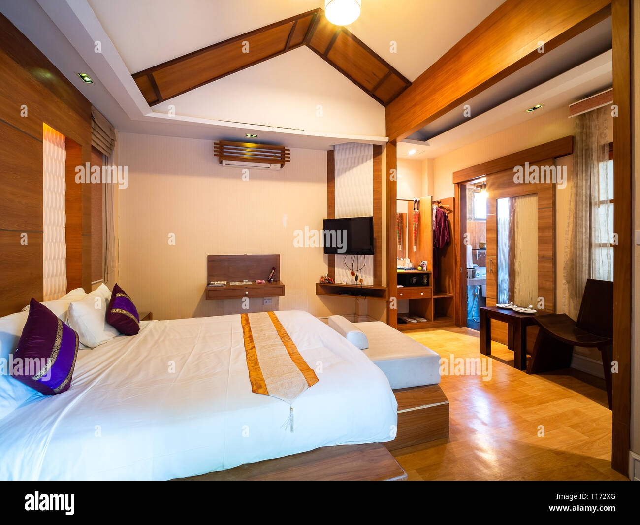 Luxury room with bed in warm light and tree view outside, room of hotel resort in Thailand. Japanese style Stock Photo