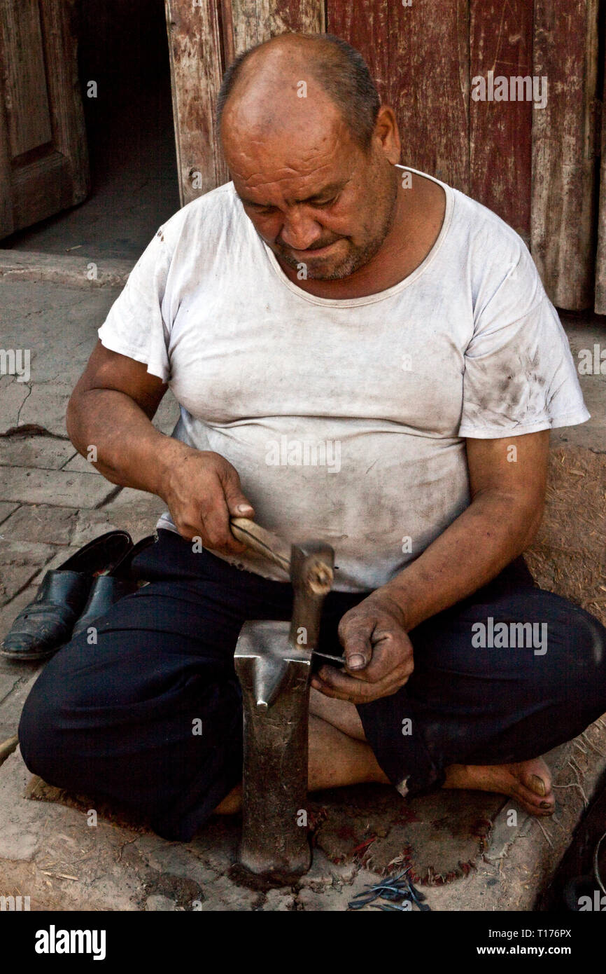 Shoe repair at Market in Hotan, Xinjiang Autonomous Region, China. Stock Photo