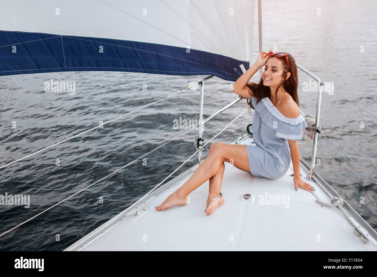 Beautiful Young Woman Sits On Yacht Bowl And Poses She Holds Red Glasses On Head With Hand And Smile Model Is Sailing On Board Of Yacht Stock Photo Alamy Beautiful Young Woman Sits On Yacht Bowl And Poses She Holds Red Glasses On Head With Hand And Smile Model Is Sailing On Board Of Yacht Stock Photo Alamy