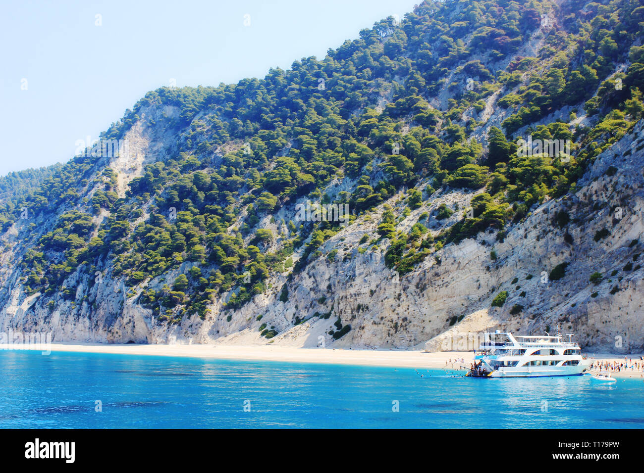 Ferry boat unloading tourists to the beautiful turquoise water Egremni beach (Ionian sea) on the island of Lefkada in Greece. Stock Photo