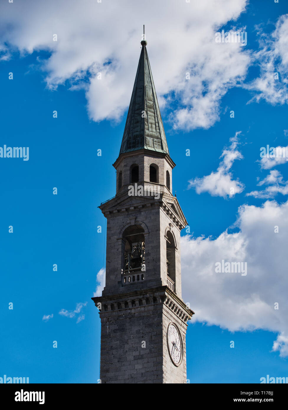 Bell tower church pinzolo Italy against cloudy blue vivid sky Stock Photo