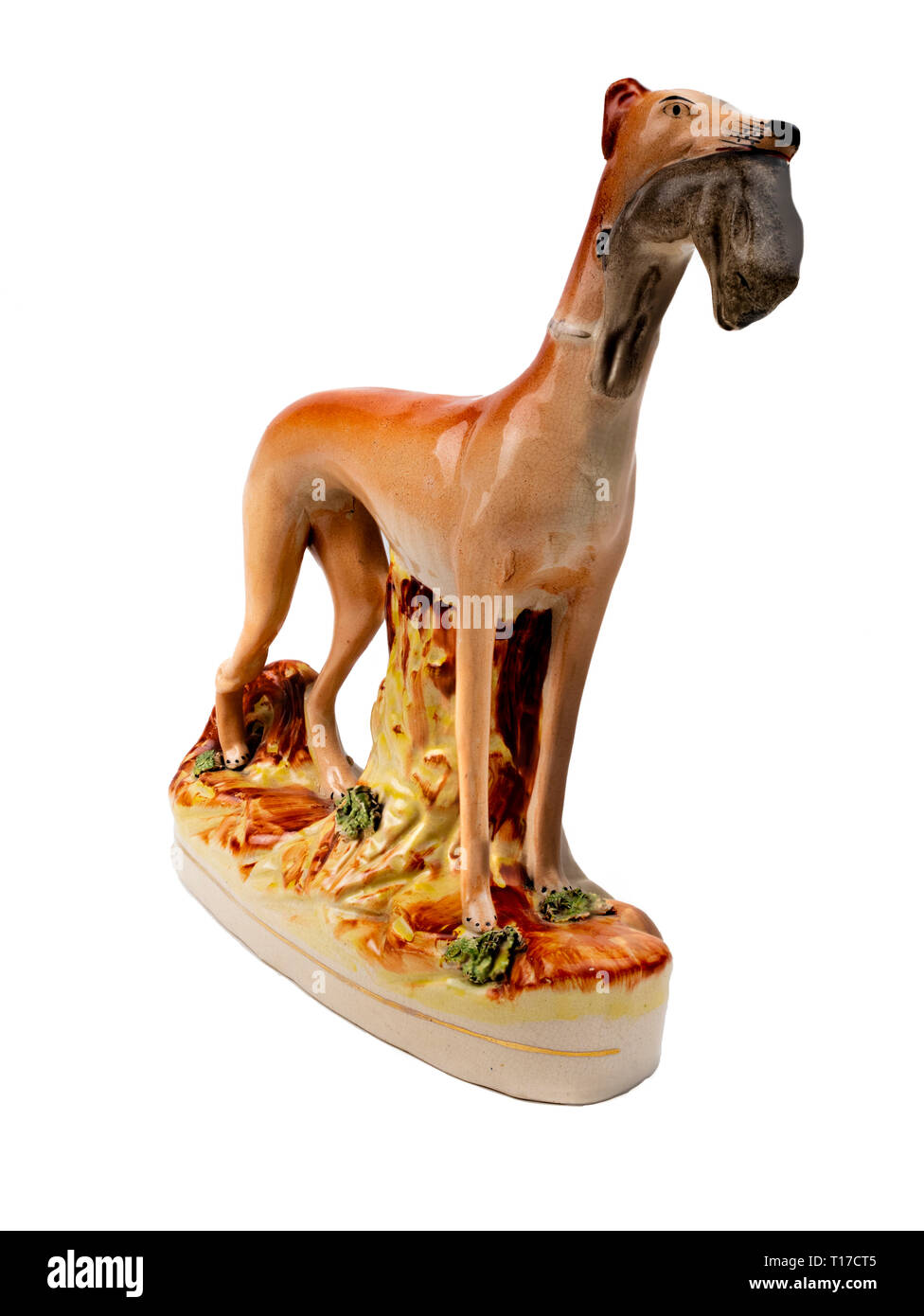 Staffordshire pottery standing greyhound with hare in it's mouth.  This are probably a reproduction. Stock Photo