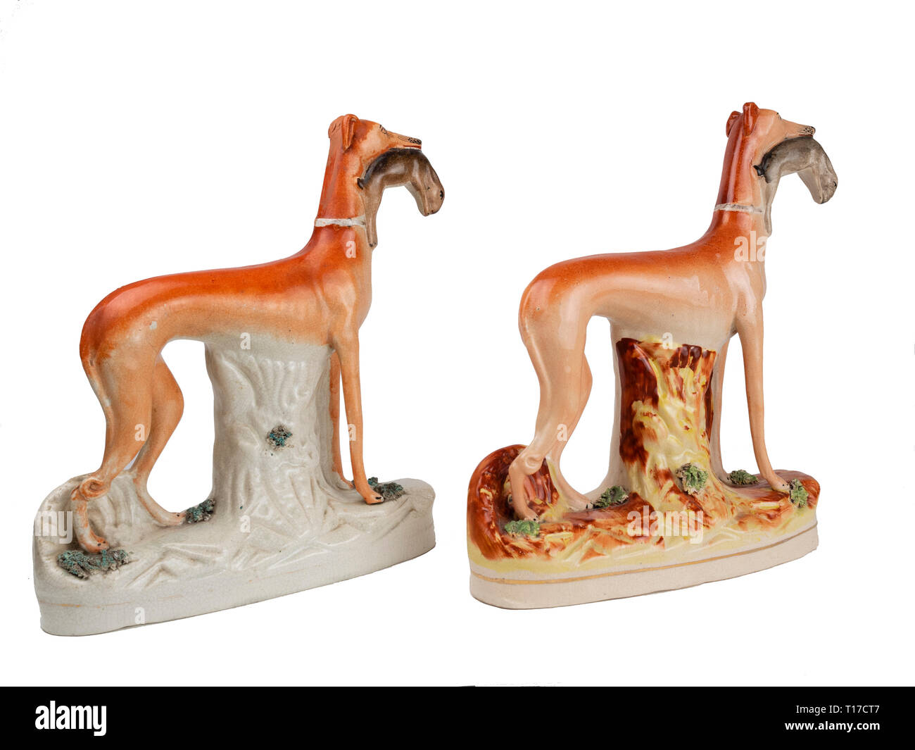 Pair of Staffordshire pottery standing greyhounds with hares in their mouths.  These are probably reproductions. Stock Photo