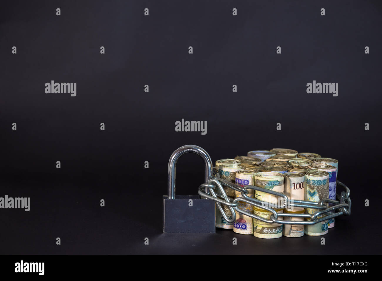 Bundles of naira cash chained and padlock concept of Esecurity on black background Stock Photo