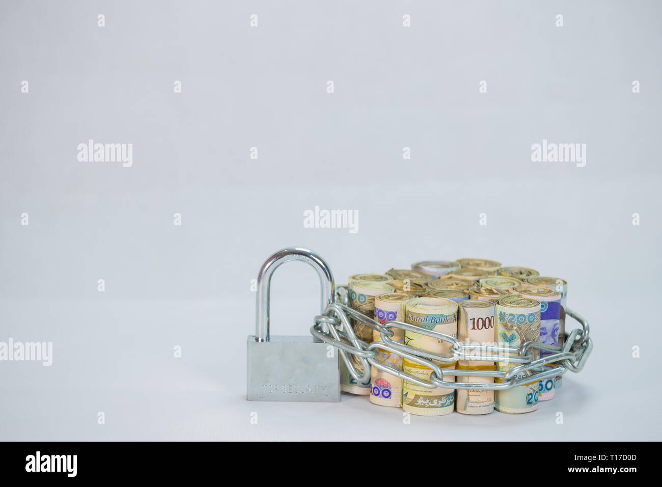 Bundles of naira cash chained and padlock concept of Esecurity on white background Stock Photo