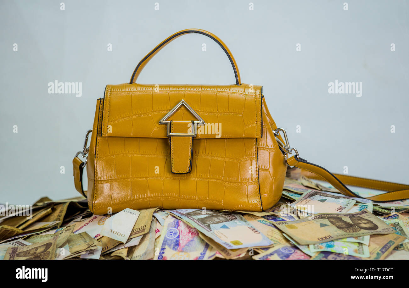 Naira cash heap with womens bag - concept of high fashion cost on white background Stock Photo