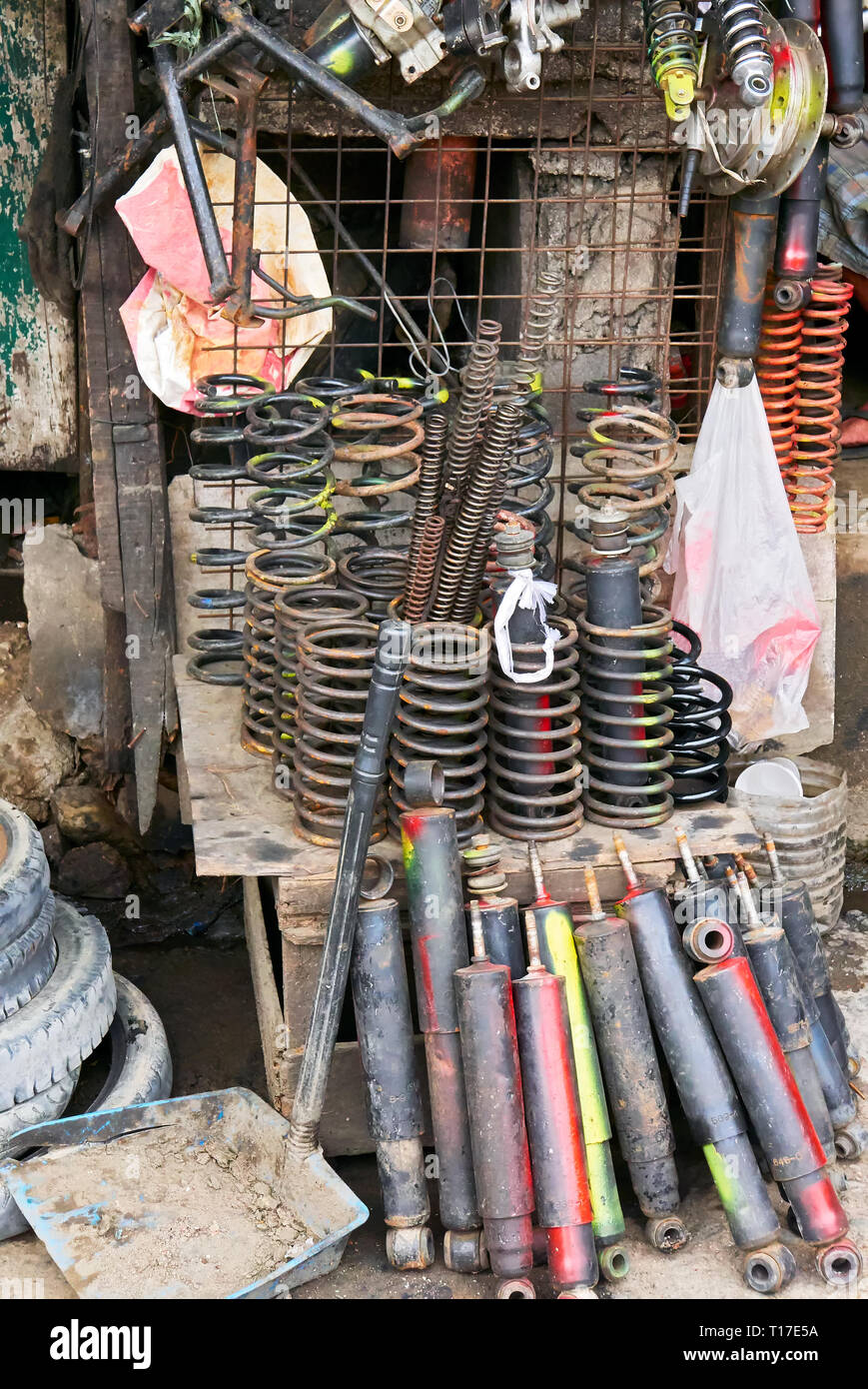 Variety of used refurbished and partly painted auto and motorbike springs and shock absorber for sale at a poor market stall in the Philippines Stock Photo