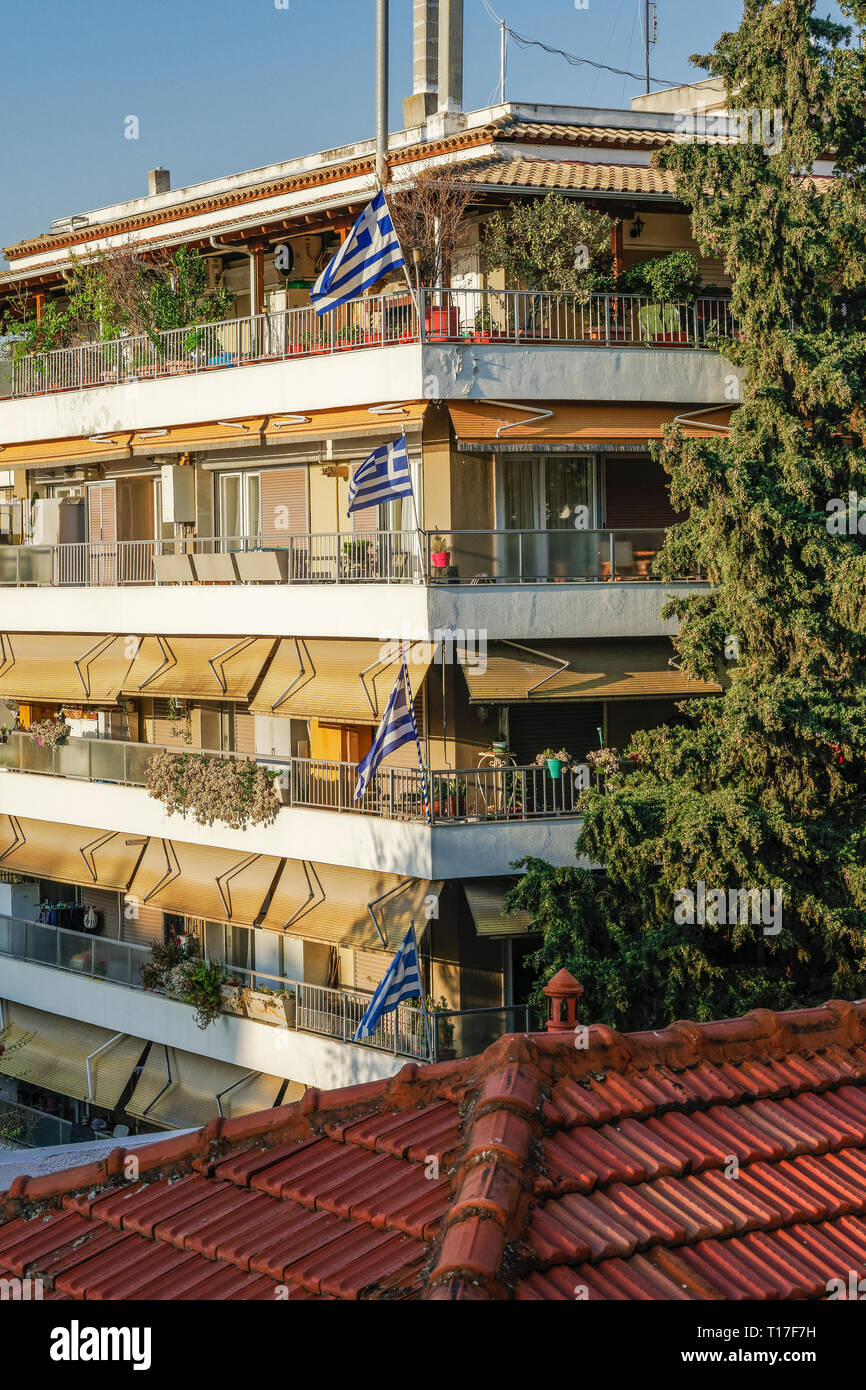 Blue and white Greek flags with cross, waving outside balconies, celebrating the March 25 1821 day of Greek War of Independence. Stock Photo