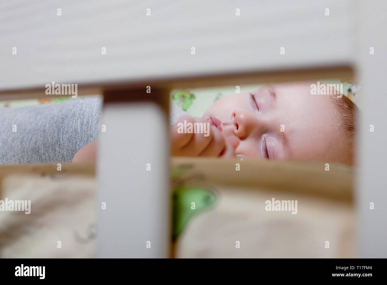 Baby's restful sleep. Newborn baby in a wooden crib. The baby sleeps in