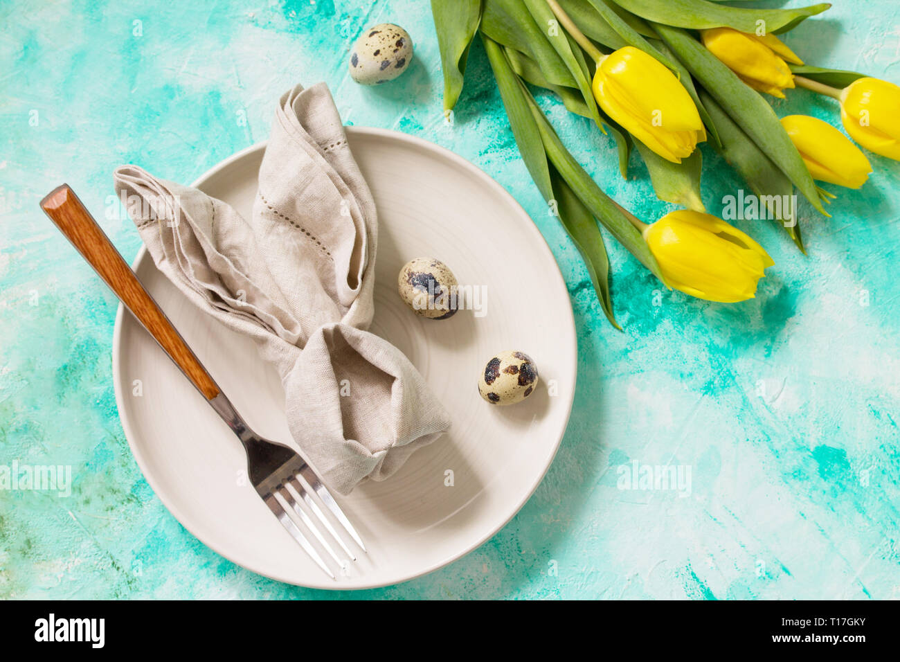Holidays background. Easter table setting with tulips flowers. Stock Photo