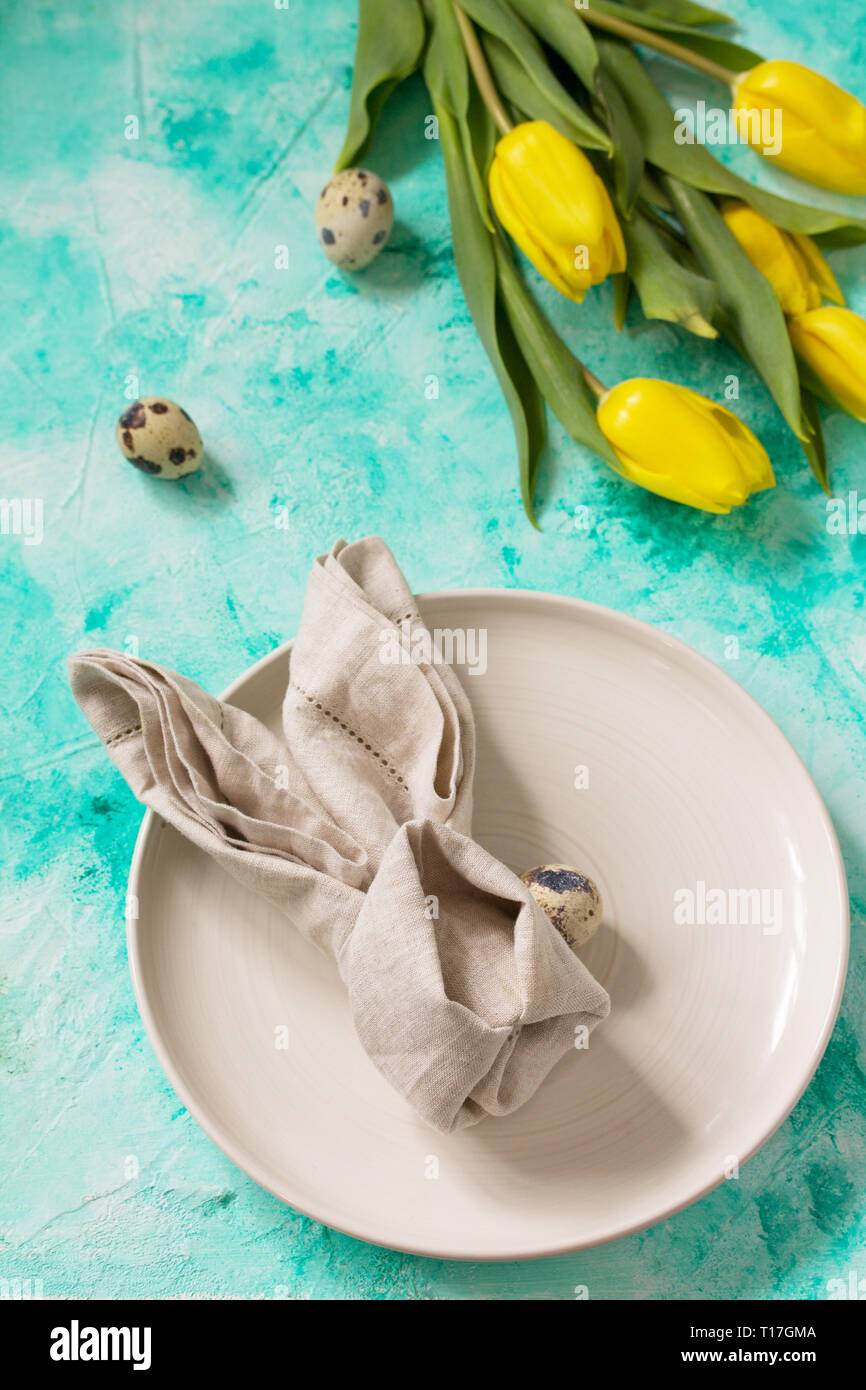 Holidays background. Easter table setting with tulips flowers. Stock Photo