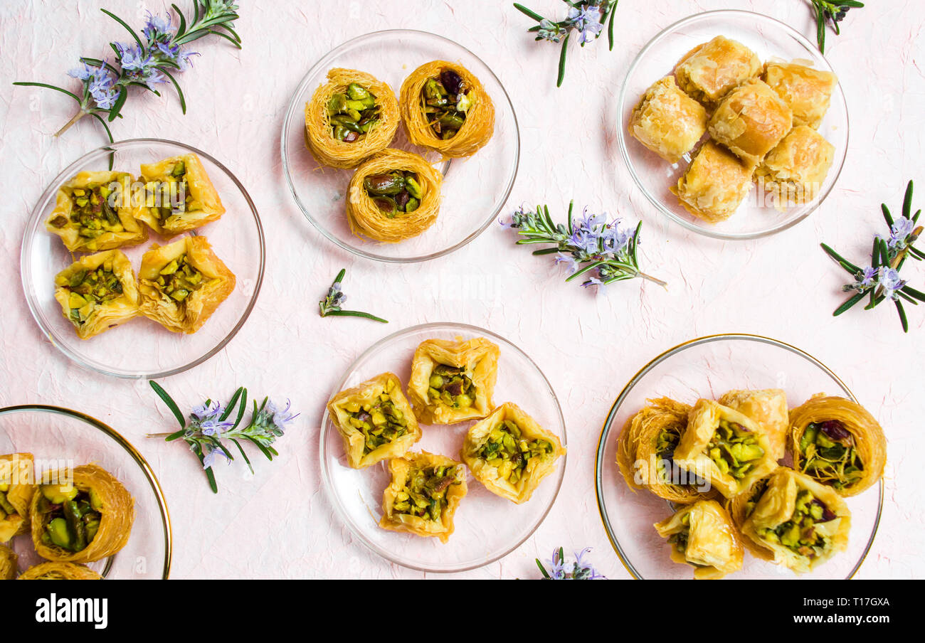 Various Arabic desserts on plates top view Stock Photo