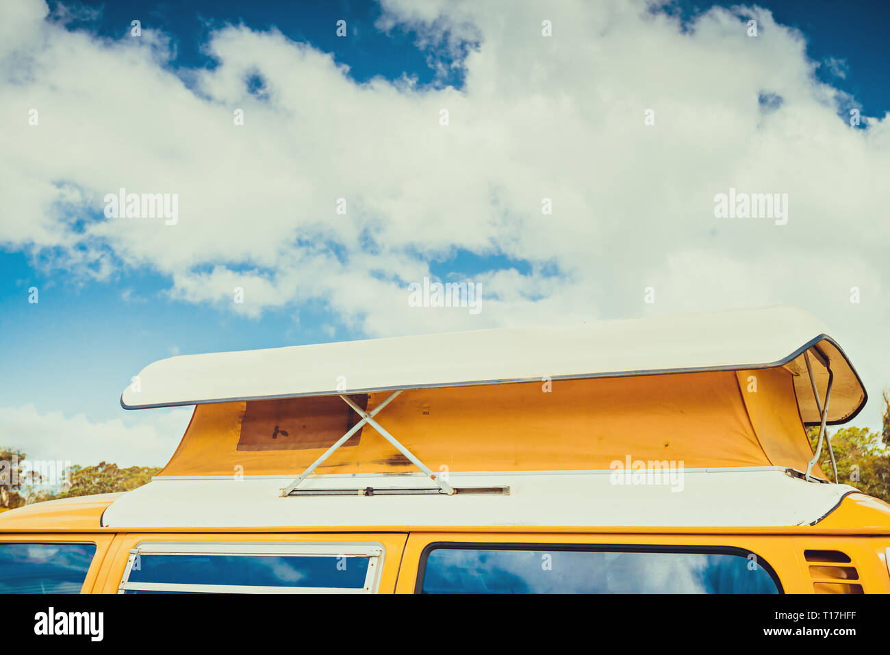 Old australian camper van with flag of Australia behind its rear window parked in caravan park on a day Stock Photo