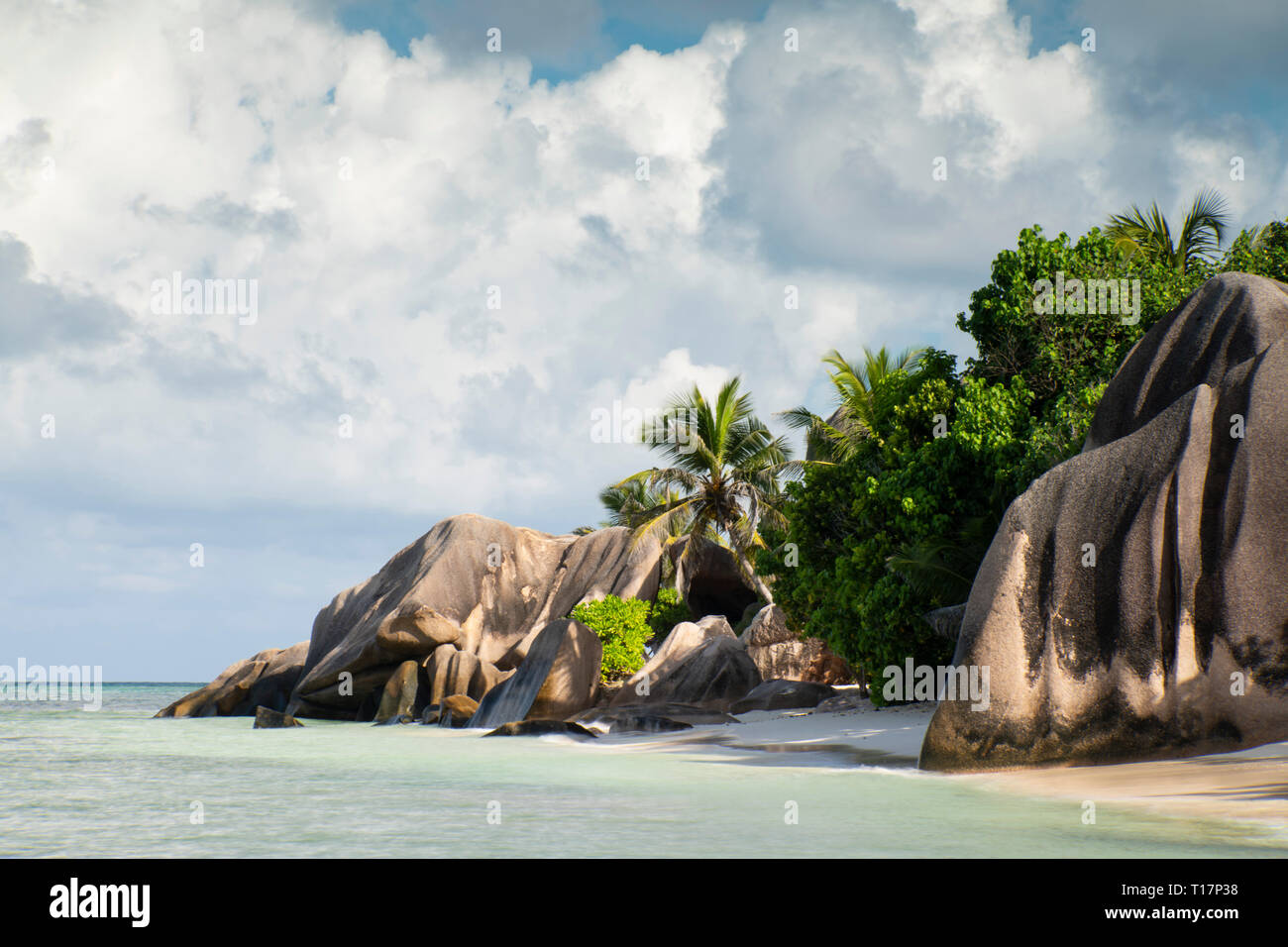 Large granite boulders and palm trees on L’Anse Source d’Argent, La Digue, the Seychelles Stock Photo