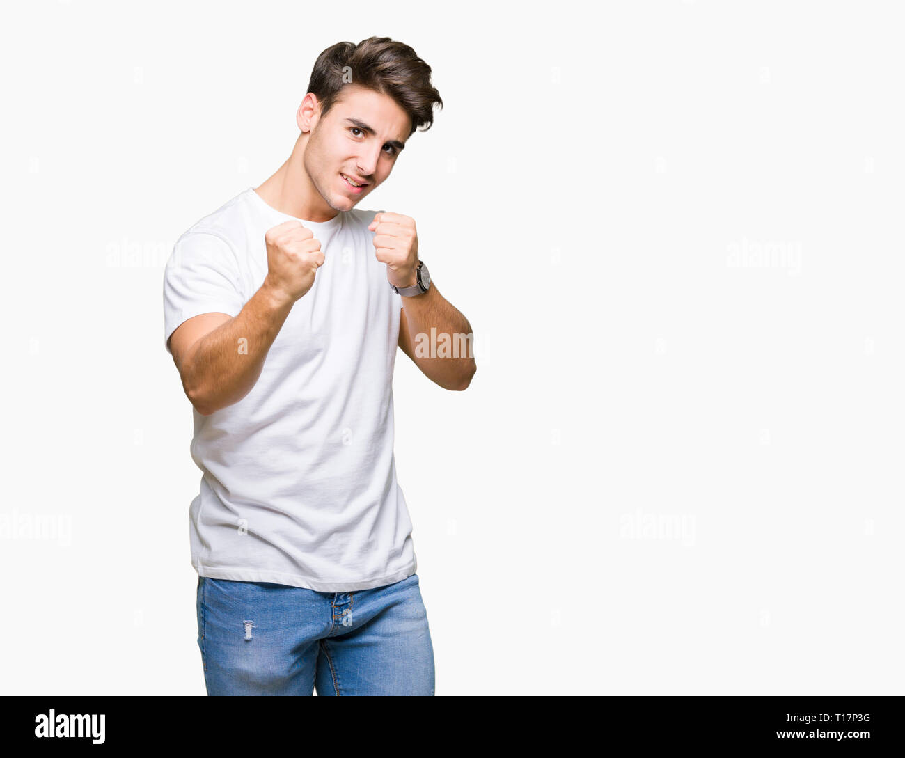 Young handsome man wearing white tshirt over isolated background Ready