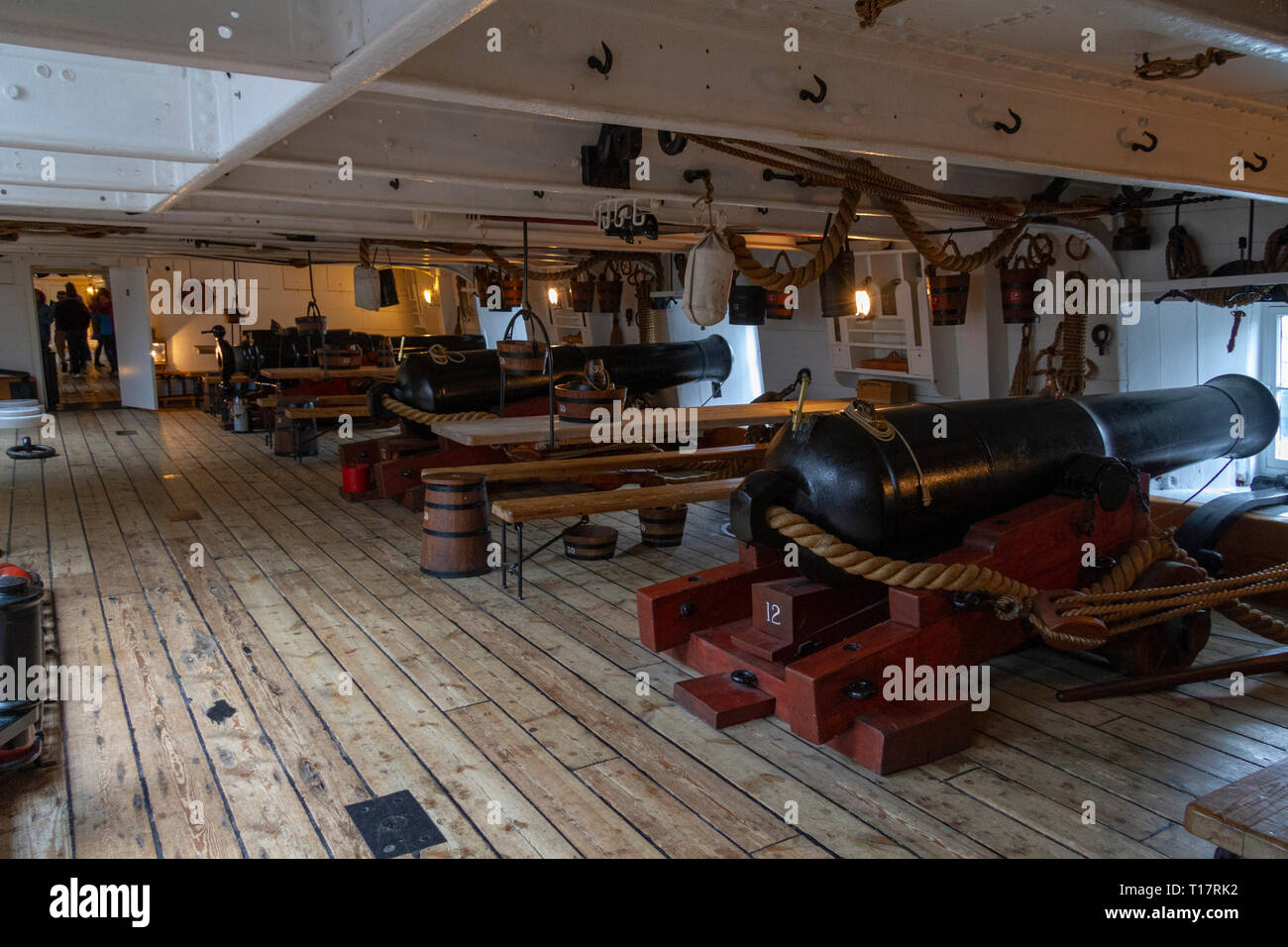 General view below deck of a line of cannon on the gun deck of HMS Warrior (1860), Portsmouth Historic Dockyard, UK. Stock Photo