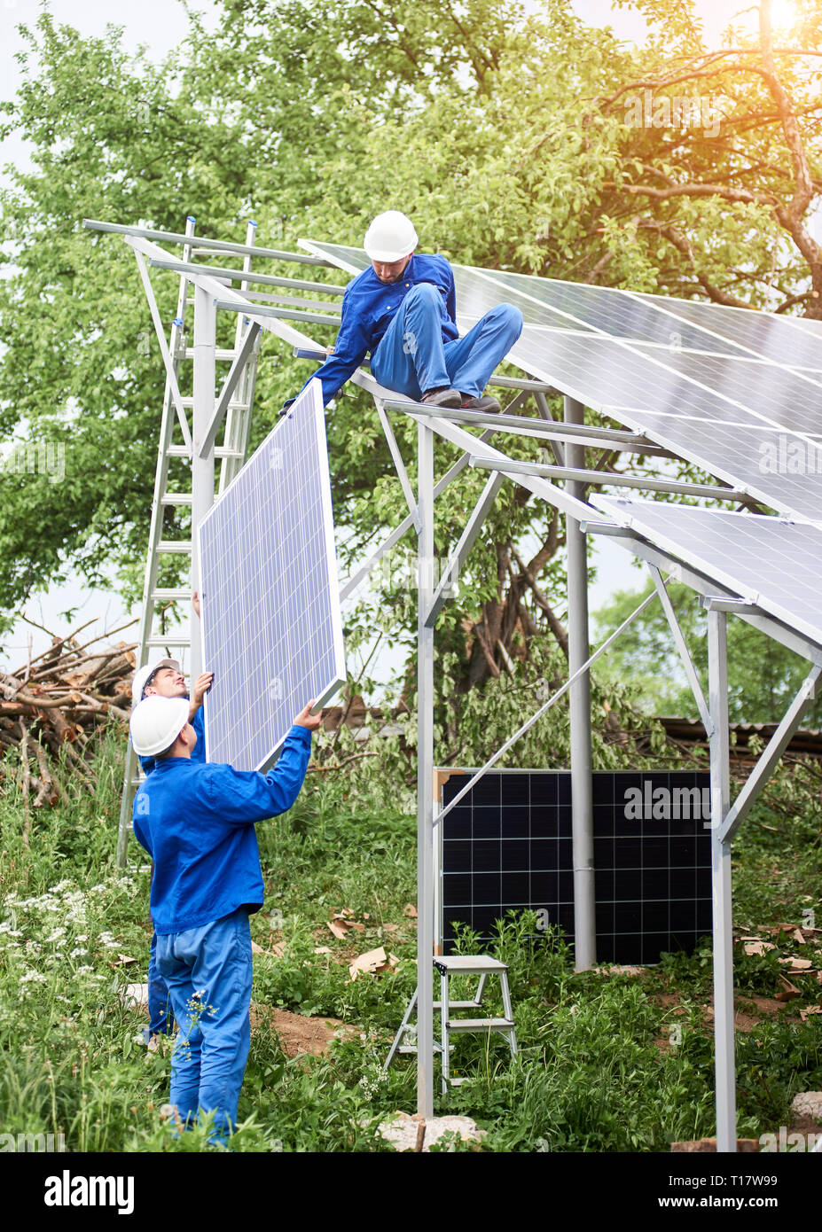 Installing of stand-alone solar photo voltaic panel system. Workers in ...