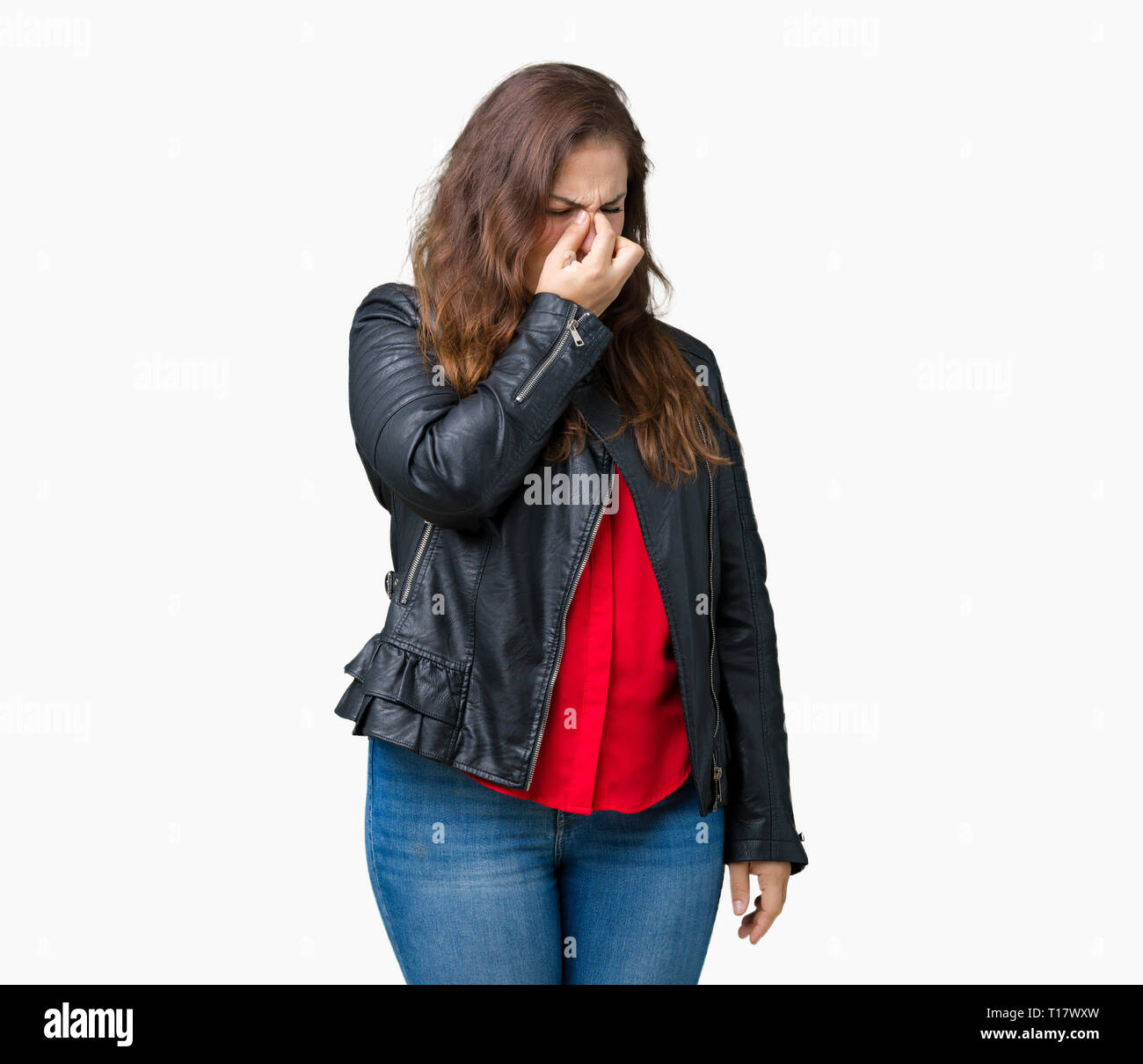 Beautiful plus size young woman wearing a fashion leather jacket over  isolated background tired rubbing nose and eyes feeling fatigue and  headache. St Stock Photo - Alamy