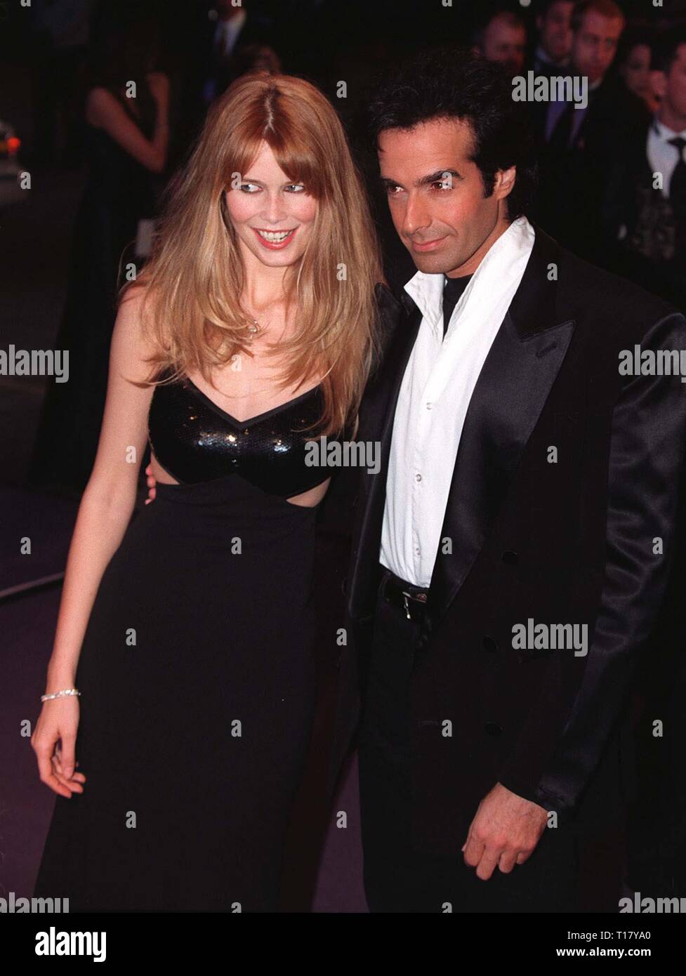 LOS ANGELES, CA. February 16, 1997:   David Copperfield & model Claudia Schiffer arriving at the Pantages Theatre, Hollywood, for Elizabeth Taylor's birthday celebration gala.    Pix: PAUL SMITH Stock Photo