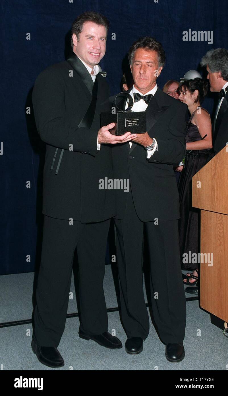 LOS ANGELES, CA. September 13, 1997:   Dustin Hoffman (left) presents John Travolta with the American Cinematheque Award at the Moving Picture Ball in Beverly Hills. They both star in the upcoming movie 'Mad City.' Stock Photo