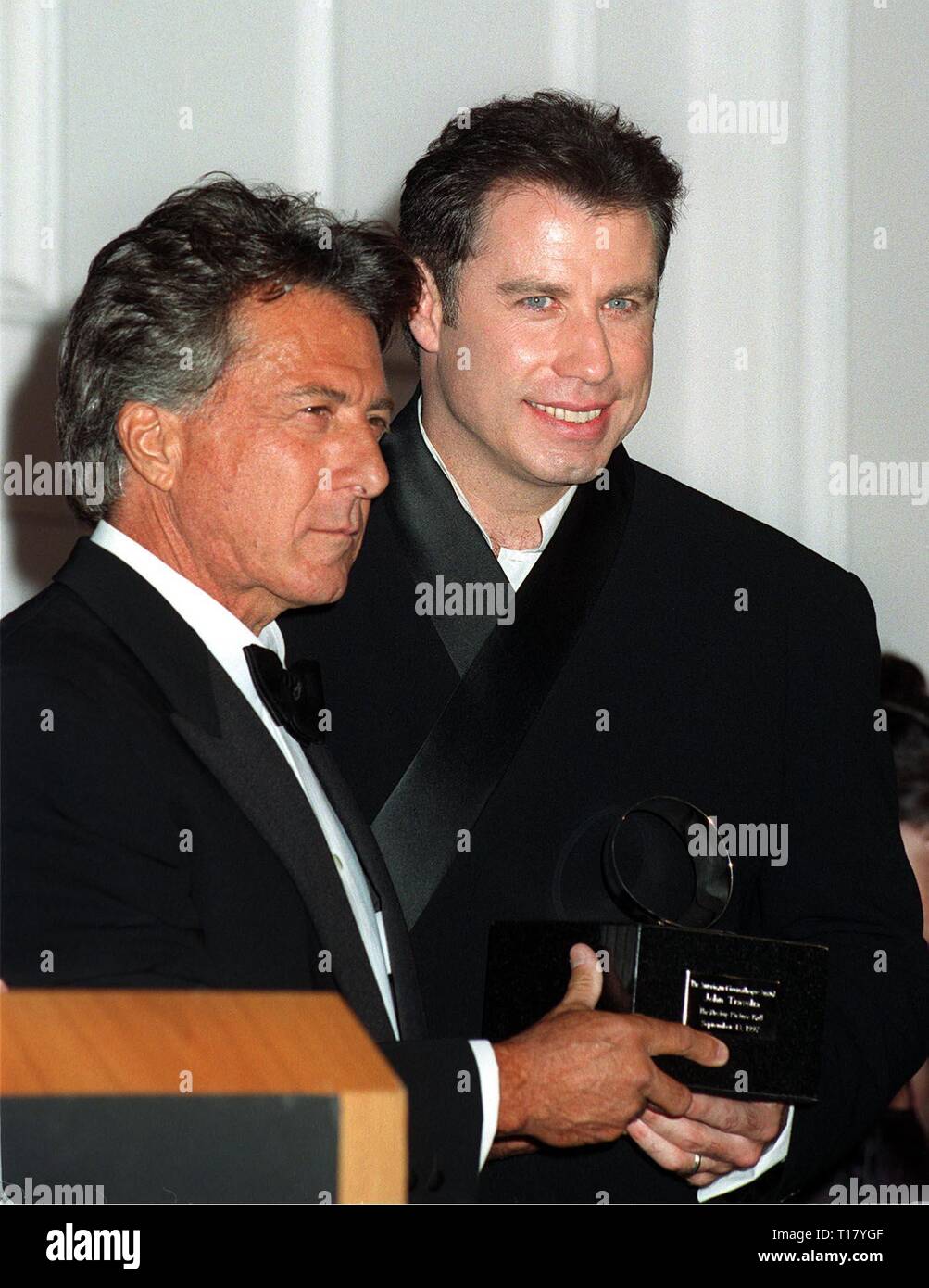 LOS ANGELES, CA. September 13, 1997:   Dustin Hoffman (left) presents John Travolta with the American Cinematheque Award at the Moving Picture Ball in Beverly Hills. They both star in the upcoming movie 'Mad City.' Stock Photo