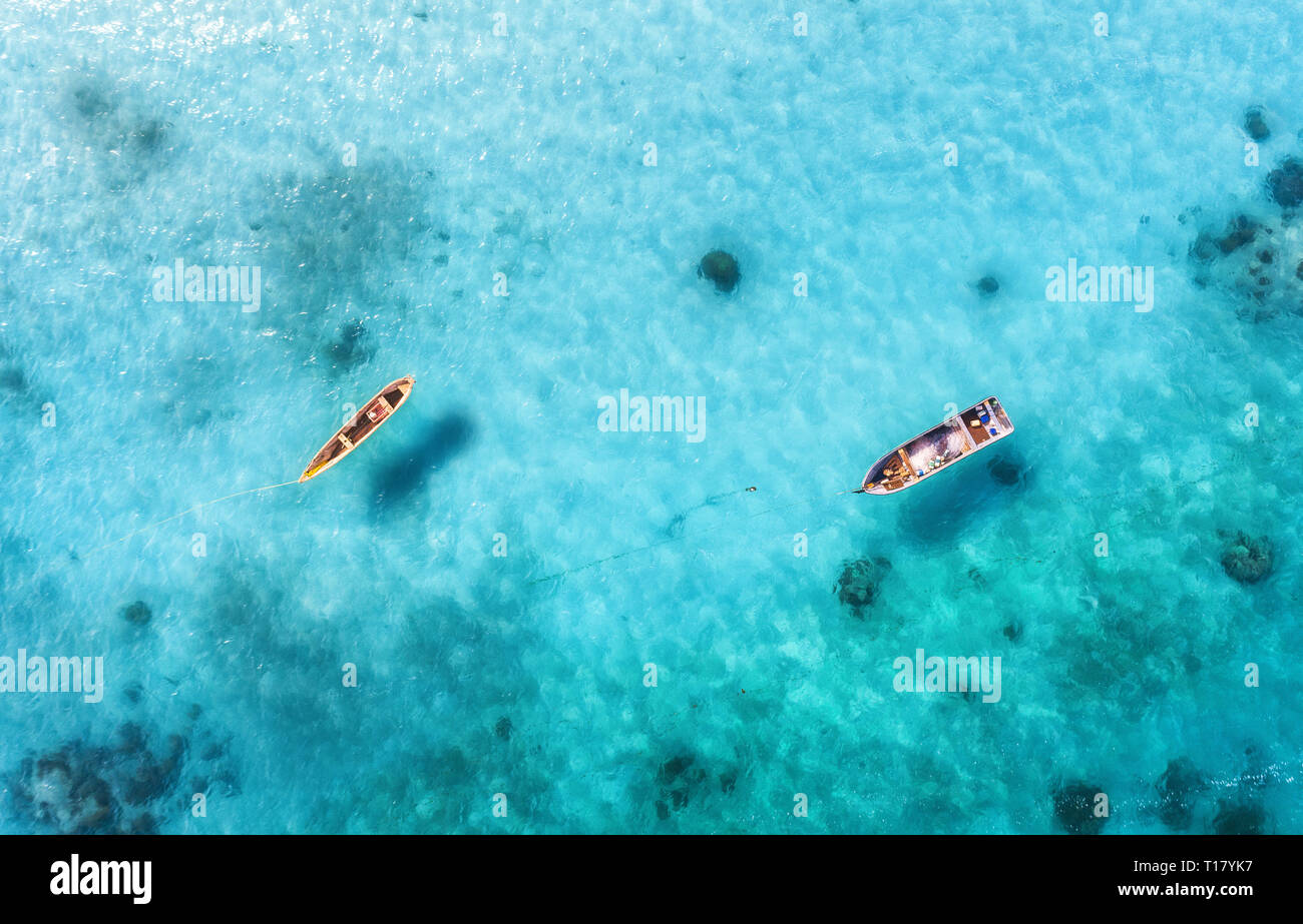 Aerial view of the fishing boats in clear blue water at sunny day in  summer. Top view from drone of boat, sandy beach. Indian ocean in Zanzibar,  Afric Stock Photo - Alamy