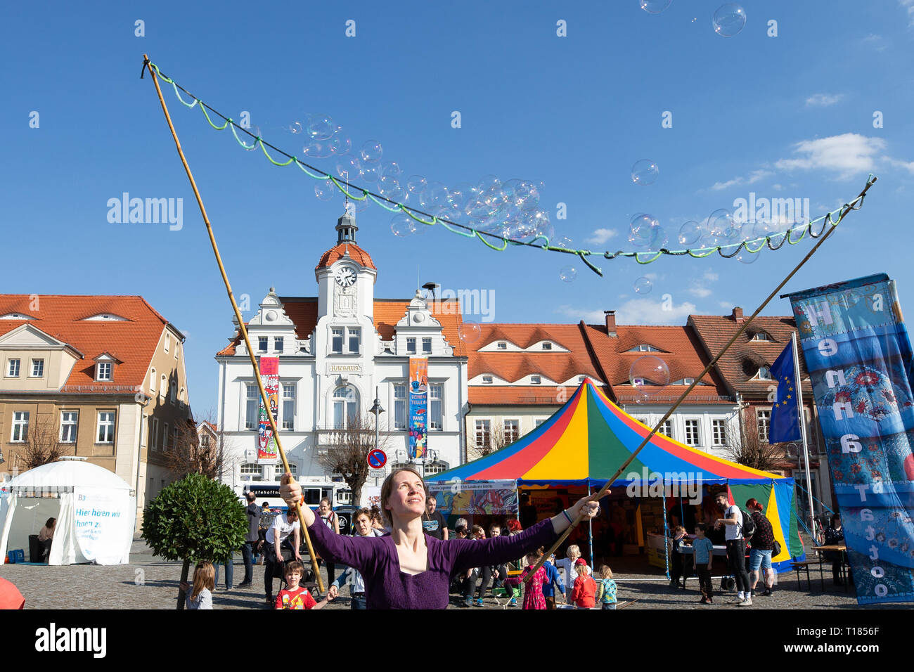 Ostritz, Germany. 23rd Mar, 2019. Tabea Scheinflug from Görlitz created soap bubbles on the market square. The city of Ostritz wants to react to the neo-Nazi festival 'Skinheads Back to the Roots' with a peace festival. Credit: Daniel Schäfer/dpa/Alamy Live News Stock Photo