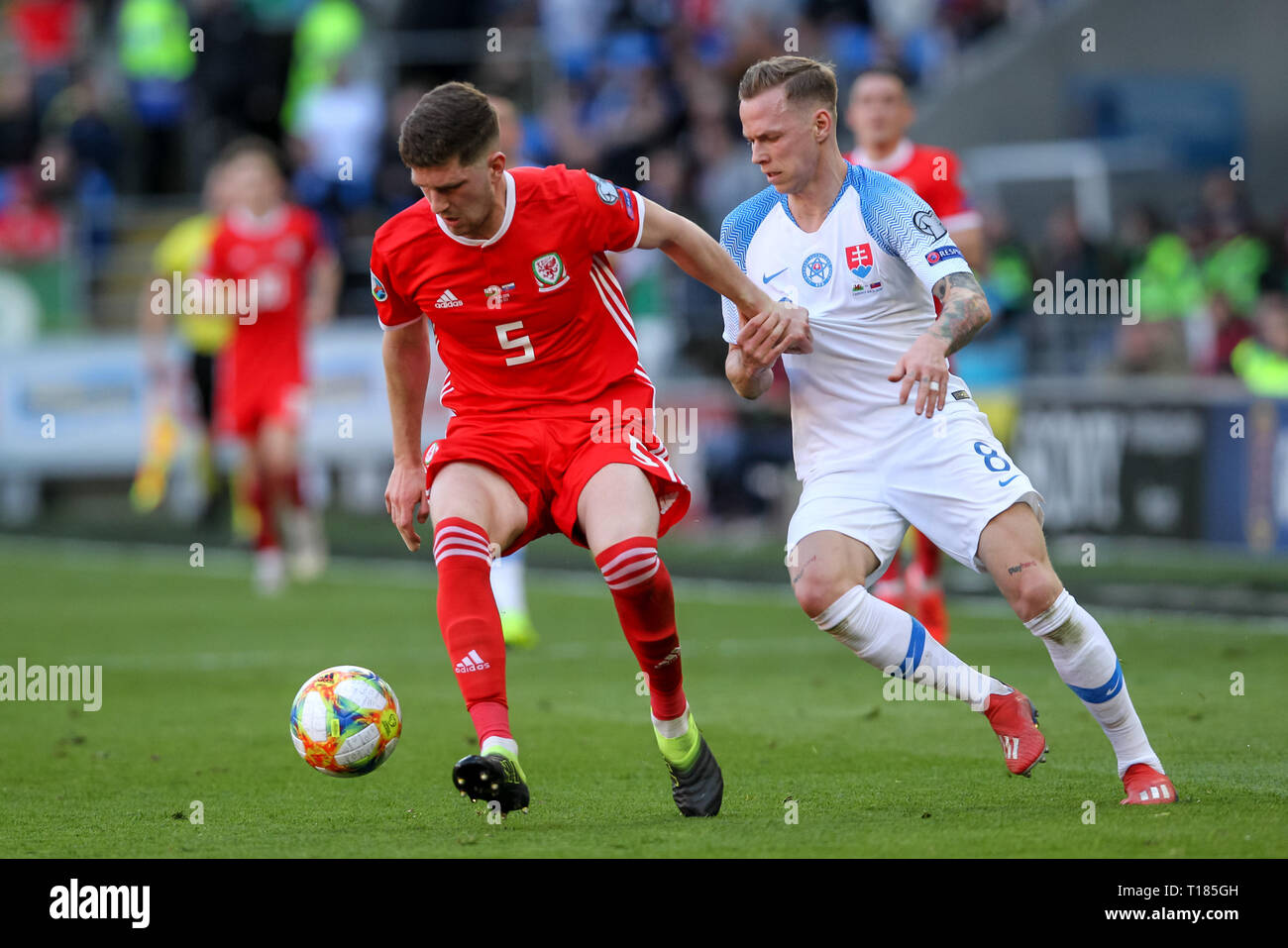 Cardiff, UK. 24th Mar, 2019.  Chris Mepham of Wales and Ondrej Duda of Slovakia challenge for the ball during the 2020 UEFA Euro Qualifier group E match between Wales and Slovakia at  the Cardiff City Stadium, Cardiff, Wales on 24 March 2019. Photo by Ken Sparks.  Editorial use only, license required for commercial use. No use in betting, games or a single club/league/player publications. Credit: UK Sports Pics Ltd/Alamy Live News Stock Photo
