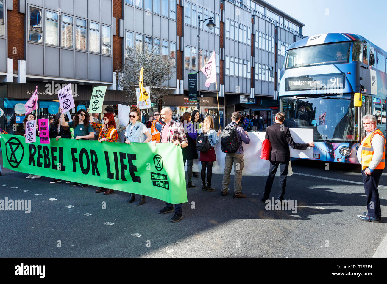 Crouch End, London, UK. 24th March 2019. “Rebel For Life”: the Campaign group Extinction Rebellion stop traffic in a peaceful demonstration on climate change. Traffic was stopped for just four minutes at a time. Credit: Michael Heath/Alamy Live News Stock Photo