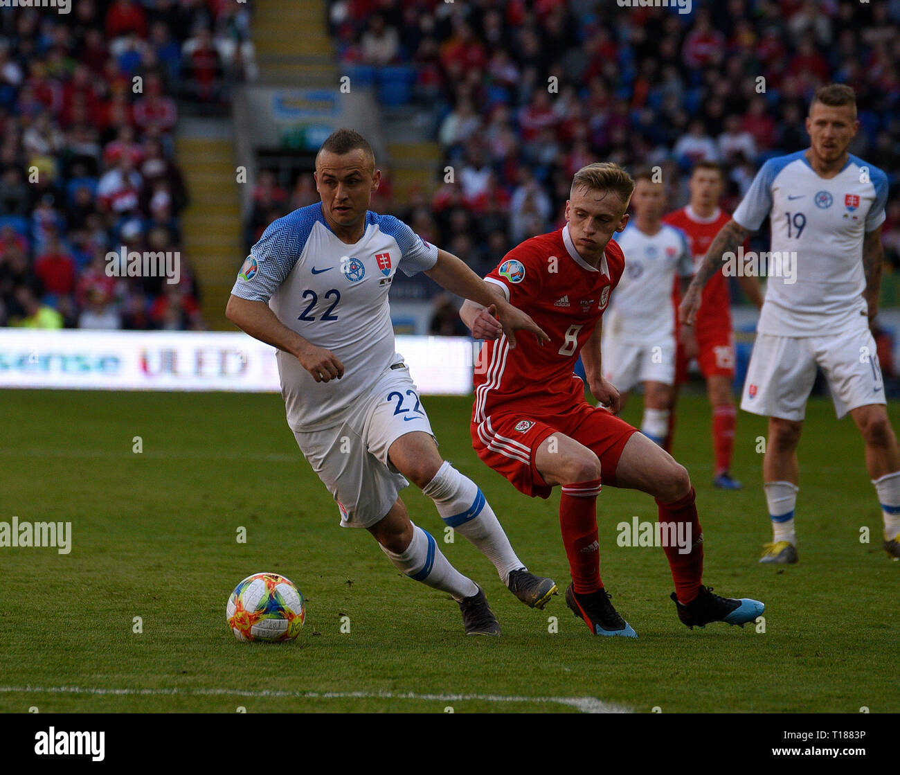 Cardiff, Wales, UK. 24th Mar 2019. Football, UEFA European Qualifiers Group E, Wales v Slovakia, 24/03/19, Cardiff City Stadium, K.O 2PM  Wales' Matt Smith tries to tackle Slovakia's Stanislav Lobotka  Andrew Dowling Credit: Andrew Dowling/Influential Photography/Alamy Live News Stock Photo