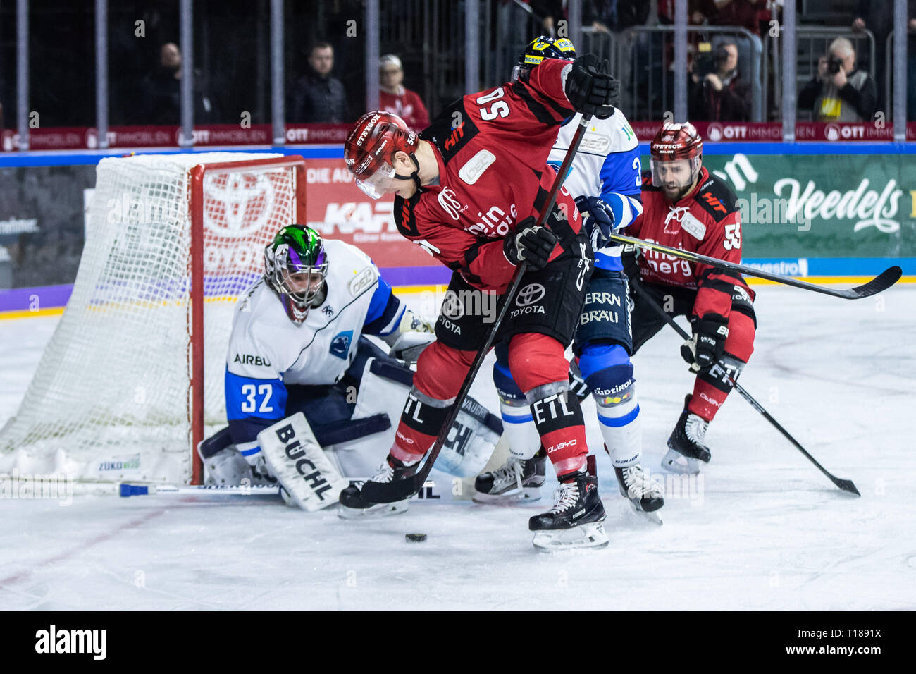 Colonge, Germany. 24th Mar 2019. Ice hockey: DEL, Kölner Haie - ERC Ingolstadt, championship round, quarter finals, 5th matchday in the Lanxess Arena. Cologne's Alexander Oblinger (2nd from left) tries to shoot the puck into the goal of Ingolstadt's goalkeeper Jochen Reimer (left). Ingolstadt's Sean Sullivan (2nd from right) and Cologne's Felix Schütz (r) try to defend. Photo: Marcel Kusch/dpa Credit: dpa picture alliance/Alamy Live News Stock Photo