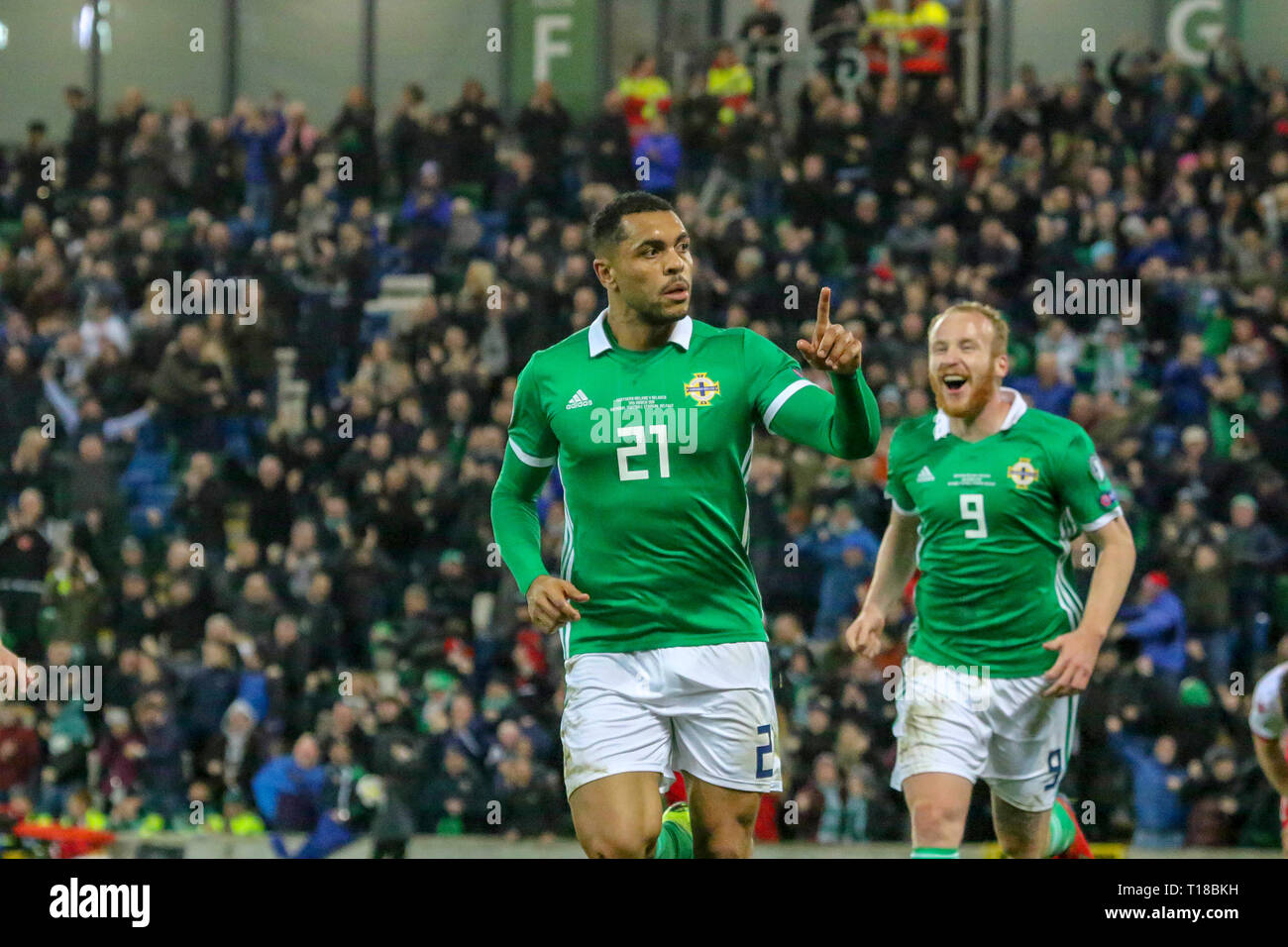 National Football Stadium at Windsor Park, Belfast, Northern Ireland. 24  March 2019. UEFA EURO 2020 Qualifier- Northern Ireland v Belarus. Action from tonight's game. Josh Magennis  (21) celebrates his winner for Northern Ireland with Liam Boyce (9). Credit: David Hunter/Alamy Live News. Stock Photo